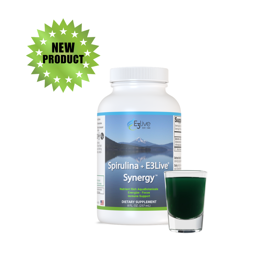 Spirulina + E3Live Synergy 8oz fresh-frozen bottle beside a shot glass of dark green liquid